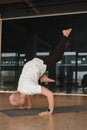 An athletic young man does exercises in the fitness room. A professional guy does yoga in the gym Royalty Free Stock Photo