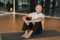 An athletic young man does exercises in the fitness room. A professional guy does yoga in the gym Royalty Free Stock Photo