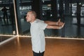 An athletic young man does exercises in the fitness room. A professional guy does yoga in the gym Royalty Free Stock Photo