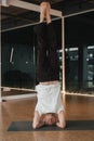 An athletic young man does exercises in the fitness room. A professional guy does yoga in the gym Royalty Free Stock Photo