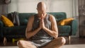 Athletic Young Man Exercising, Doing Meditation in the Morning in His Bright, Sunny and Stylish Room Royalty Free Stock Photo