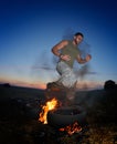 Athletic young man exercising on dusty field Royalty Free Stock Photo