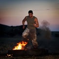 Athletic young man exercising on dusty field Royalty Free Stock Photo