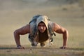 Athletic young man exercising outdoor on dusty field Royalty Free Stock Photo