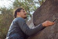 Athletic young man holding on rock Royalty Free Stock Photo