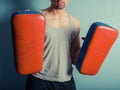 Athletic young man with martial arts pads Royalty Free Stock Photo