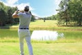 Athletic young man playing golf in golfclub