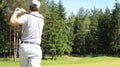 Athletic young man playing golf in golfclub