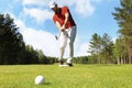 Athletic young man playing golf in golfclub. Royalty Free Stock Photo