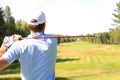 Athletic young man playing golf in golfclub