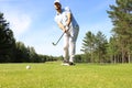 Athletic young man playing golf in golfclub