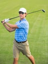 Athletic young man playing golf Royalty Free Stock Photo