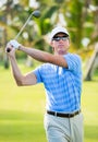 Athletic young man playing golf Royalty Free Stock Photo