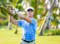 Athletic young man playing golf Royalty Free Stock Photo