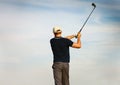 Athletic young man playing golf, golfer hitting fairway shot Royalty Free Stock Photo