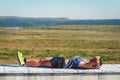 Athletic young man resting on a stone bench after a hard hiking day in Palencia, Spain. Lifestyle concept