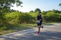 Athletic young man running in the nature. Urban healthy active lifestyle