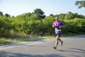 Athletic young man running in the nature. Urban healthy active lifestyle