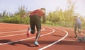 Athletic young man running on race track with bokeh green background