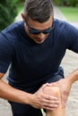 Athletic Young Man with Sore Knee Royalty Free Stock Photo