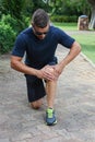 Athletic Young Man with Sore Knee Royalty Free Stock Photo