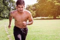 Athletic young man streching his legs in the sports ground. Healthy lifestyle , fitness and sports concept.