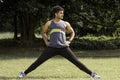 Athletic young man streching his legs in the sports ground. Healthy lifestyle , fitness and sports concept.