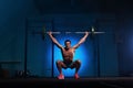 Athletic young man working out with barbell in gym Royalty Free Stock Photo