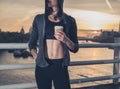 Athletic young woman with cup in London at sunrise Royalty Free Stock Photo