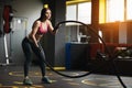 Athletic young woman doing crossfit exercises with a rope. Royalty Free Stock Photo