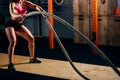 Athletic young woman doing some cross fit exercises with rope outdoor Royalty Free Stock Photo