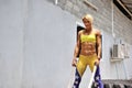 Athletic young woman doing some crossfit exercises with a rope o