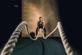 Battling ropes girl at gym workout exercise fitted body Royalty Free Stock Photo