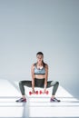 athletic young woman doing squat exercise with dumbbells and looking Royalty Free Stock Photo