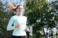 Athletic young woman jogging, running and training outdoors on a sunny day in summer Royalty Free Stock Photo