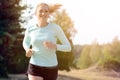 Athletic young woman jogging, running and training outdoors on a sunny day in summer Royalty Free Stock Photo