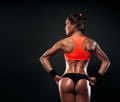 Athletic young woman showing muscles of the back Royalty Free Stock Photo