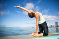 Athletic young woman in SUP Yoga practice back bend Pose in Ala