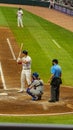 An Atlanta Braves baseball player standing on that plate holding a bat with the Los Angeles Dodgers catcher and the umpire