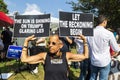 Female holds anti-Trump signs outside Fulton County Jail