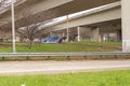 Homeless people camped out under a bridge multiple tents Royalty Free Stock Photo