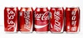 Atlanta, Georgia, USA April 4, 2020: five cans of Coca-Cola with a logo in different languages: Russian, Arabic, Korean