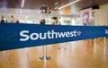 Blue barrier tape with Southwest Airlines logo inside an airport