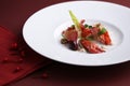 Atlantic blue lobster salad marinated on white plate in black ba