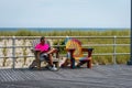 ATLANTIC CITY, NEW JERSEY - JUNE 18, 2019: A man resting on a bench at the edge of a wooden boardwalk