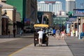 ATLANTIC CITY, NEW JERSEY - JUNE 18, 2019: A pedicab pushes his customers past the Boardwalk lined with restaurants, shop and