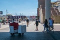 Man who pushes a famous rolling chair waits for a tourist to request a ride on the Atlantic City Boardwalk