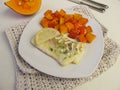 Atlantic cod fillet and red kuri squash Royalty Free Stock Photo