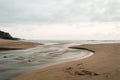 Atlantic Ocean. In the foreground, a stream flows into the sea