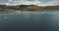 Atlantic ocean gulf, sailboats aerial zooming shot in Brodick Bay. Scottish landscape of port town Royalty Free Stock Photo